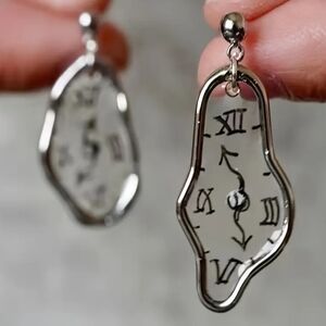 Salvatore Dali melted watch earrings in gold or silver frame.
